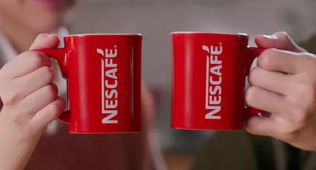 Who is the owner of Nescafé and how does Nescafé operate in Thailand?