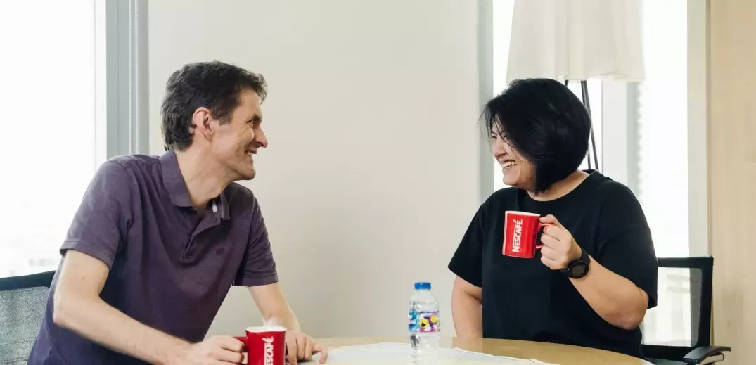 colleagues talking and drinking coffee