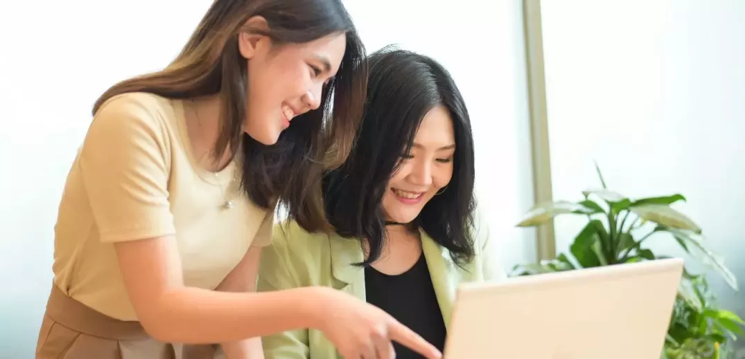 two colleagues working on laptop